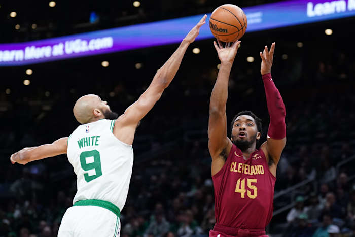 Dec 14, 2023; Boston, Massachusetts, USA; Cleveland Cavaliers guard Donovan Mitchell (45) shoots against Boston Celtics guard Derrick White (9) in the first quarter at TD Garden.